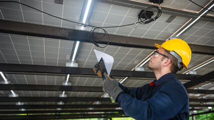 Engineer technical service checking installation solar cell panel and check all the lists on clipboard and the wire that connect to the solar panel properly