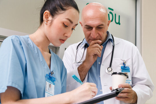 professor doctor give advice and discuss with intern student for surgery planning and patient treatment in the hospital medical school. healthcare and medical education concept.