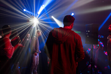 People dancing and jumping at disco. Evening enjoyment in music club. Nightlife, modern music and...