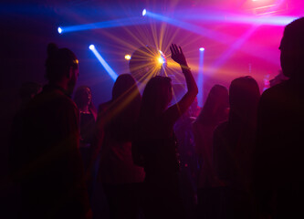 Group of men and women enjoying dancing at party in club. Nightlife, modern music and entertainment concept
