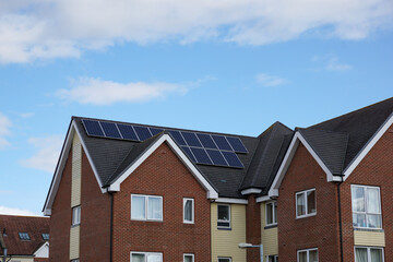residential building roof top with solar panels. new homes with renewable energy source 