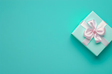 A blue box with a pink bow on top of it