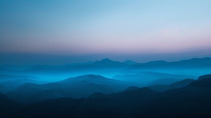Fototapeta premium A blue landscape with layers of mountains in the distance.