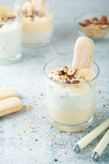 Milk mousse dessert with nuts in glasses	