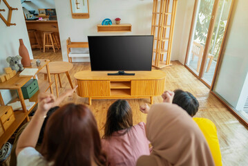 An Indonesian group of people are playing video games in a living room