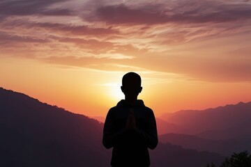 Fototapeta premium Youthful Prayer Silhouette at Stunning Sunrise Emphasizes Devotion Serenity and Faith