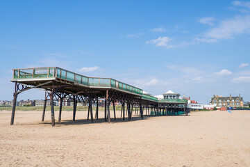 The Edwardian pier at Lytham St Annes on the sea in summer with the beach at low tide