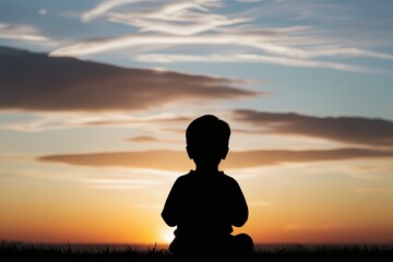 Child Praying at Sunset Emphasizing Spirituality and Connection