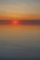 The sun sets on the water. Sunset and calm.