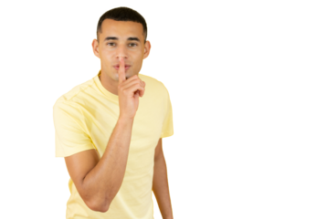 Studio portrait of a young man making a silence gesture over transparent background
