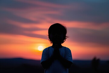 Prayerful Child Silhouette at Sunset Embracing Love Faith and Compassion