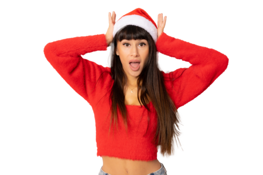 Amazed young woman in santa hat isolated over transparent background.
