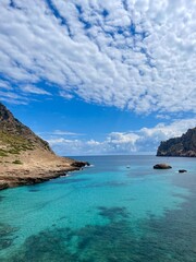 Serene Beach in Mallorca with Turquoise Waters and Majestic Mountains