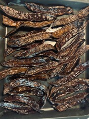 Roasted carob beans on the tray. 
