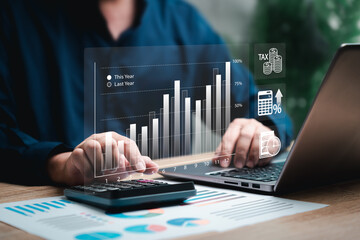 Business analysis cost comparison, Taxes payment, Businessman use Laptop and calculator for...
