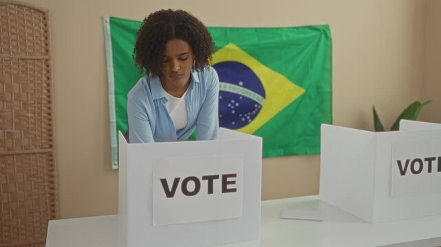 Young woman votes in an electoral college room with a brazilian flag in the background.