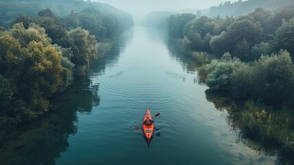 Caucasian Sportsman in the Red Kayak Paddling on the Scenic River Along the Shore.