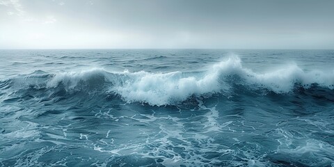 Fototapeta premium A panoramic view of endless sea waves stretching to the horizon under a uniformly gray sky, with minimalist copy space below for simplicity