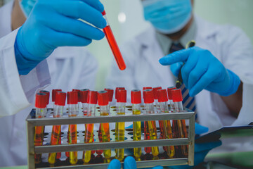 In this chemical experiment, two researchers collaborate to mix reactants, carefully observe...