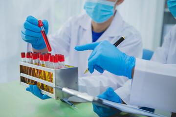 In this chemical experiment, two researchers collaborate to mix reactants, carefully observe...