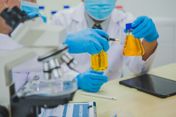 In this chemical experiment, two researchers collaborate to mix reactants, carefully observe...