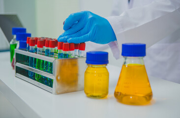 In this chemical experiment, two researchers collaborate to mix reactants, carefully observe changes such as color shifts or gas production, and analyze results, demonstrating principles of chemistry