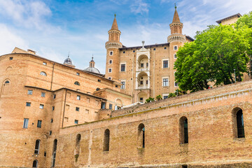 A view looking up over the city wall towards Urbino, Italy in summertime