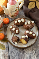 Chocolate rum potato cake with pumpkin on rustic background, homemade vegan dessert. Traditional Eastern European dish with cocoa and butter. Chocolate sweets filled with marzipan. Copy space.