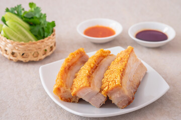 Crispy pork belly on white plate and dipping sauce