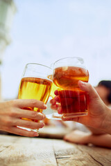 Two glasses of beer meet in cheerful toast, capturing essence of friendship and good times....