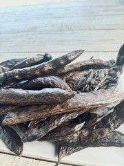 Roasted carob beans ready to be ground. 
