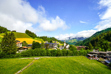 View of Auffach and the surrounding landscape. Idyllic town in the municipality of Wildschönau in the Kufstein district in Austria. Nature with mountains in Tyrol.
