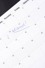 Hand fills in a large wall calendar, counting down the days until retirement, writing 'Retirement'. Concept of early retirement, the Financial Independence, Retire Early movement (FIRE)