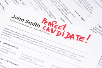 Obraz premium Fake mock CV (curriculum vitae) resume for John Smith, selected by HR as the perfect candidate for a job. Concept of job search, employee selection, recruitment process, work and hiring.