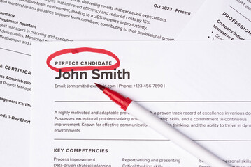Fake mock CV (curriculum vitae) resume for John Smith, selected by HR as the perfect candidate for a job. Concept of job search, employee selection, recruitment process, work and hiring.