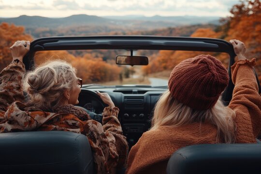 This image features friends enjoying a drive with the top down, surrounded by the vibrant colors of fall, making for a joyful and refreshing adventure.