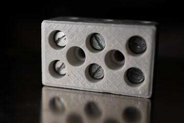 Ceramic terminal block for three wires.
