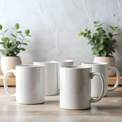 A clean and simple photo of four white mugs on a wooden table. perfect for showcasing your designs or text.