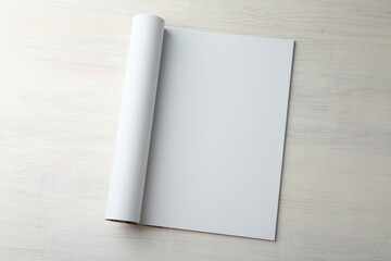 Open magazine with blank page on light wooden table, top view. Mockup for design