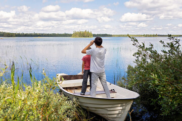 Children, playing on a boat in a river, summertime, watching nature with binoculars, sunny weather