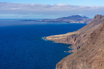 View of the Atlantic Ocean and the rocky steep coast from the observation deck - Mirador de Balcon. Gran Canaria. Canary Islands. Spain.