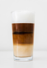 Tasty latte coffee glass cup with foam isolated on white background