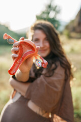 Woman holding anatomical model of uterus in close-up view