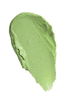 Swatch texture of green cream cray kaolin cosmetic mask for face and body on a white isolated background. Copy space