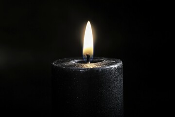 A single candle burns bright.