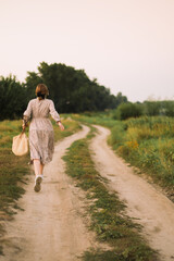 girl walks with a cat at dawn
