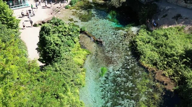 River coast dron bird view in Blue eye river, Albania. Green Seaweed leaves in Turquoise and green water river Bistrice scenic aerial view in Muzine, Finiq, Albania, Europe.