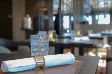 Modern contemporary colorful interior design decor inside a la carte speciality dining restaurant onboard luxury cruiseship cruise ship liner with ocean views, set tables and tableware glasses