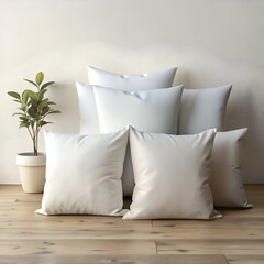 Five pristine white pillows arranged in a cozy stack. perfect for adding a touch of elegance to your home decor.