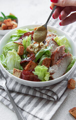 A bowl  of  Caesar salad